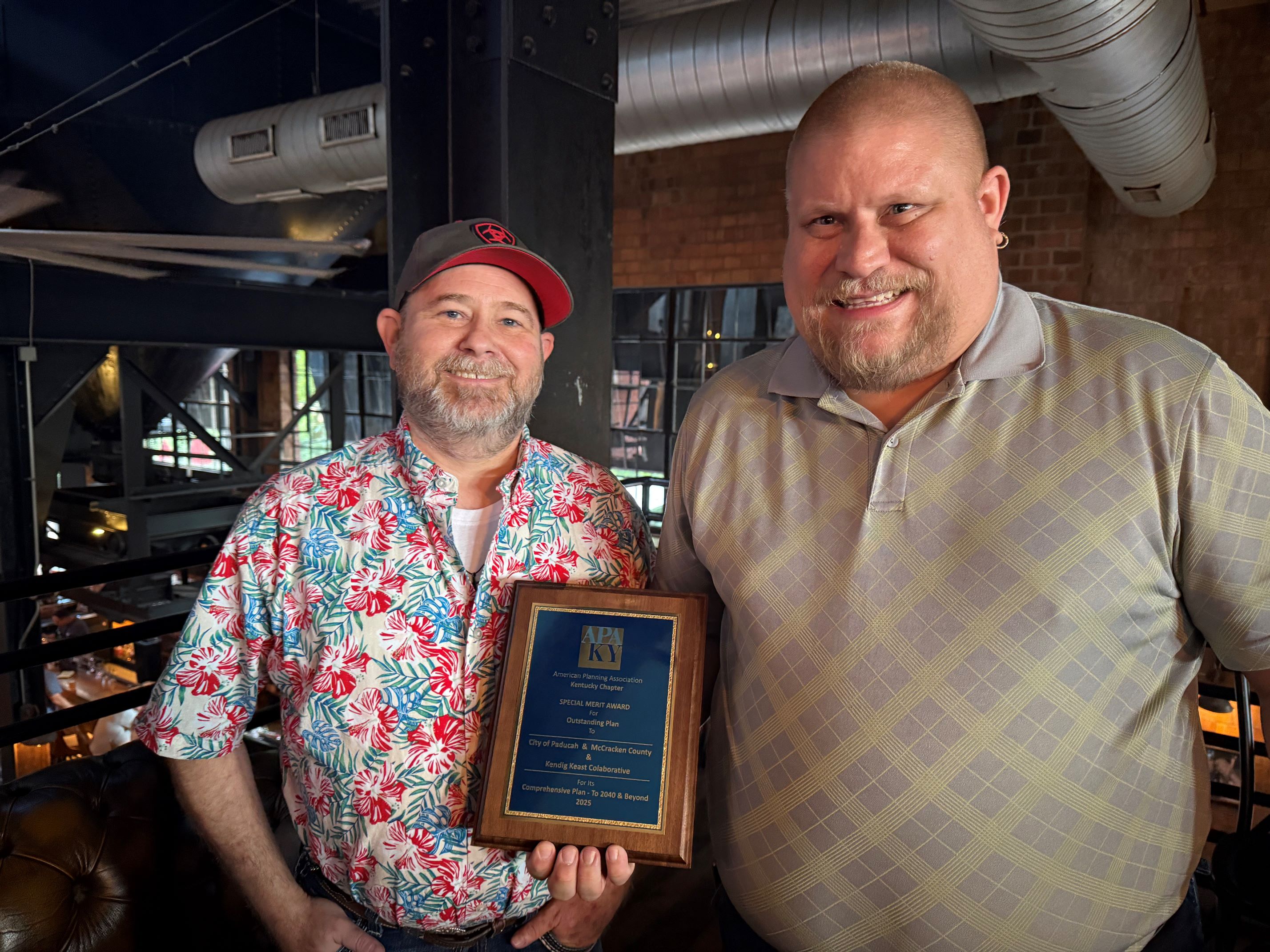 Picture of Josh Fowler-Sommer and Greg Cannon holding the Comprehensive Plan award.